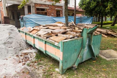 Collection crew loading household items for recycling in Wembley